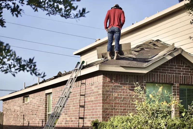 Professional roofer working on a residential roof in Lumkins